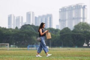 Woman walking outdoors on a hazy day in Singapore